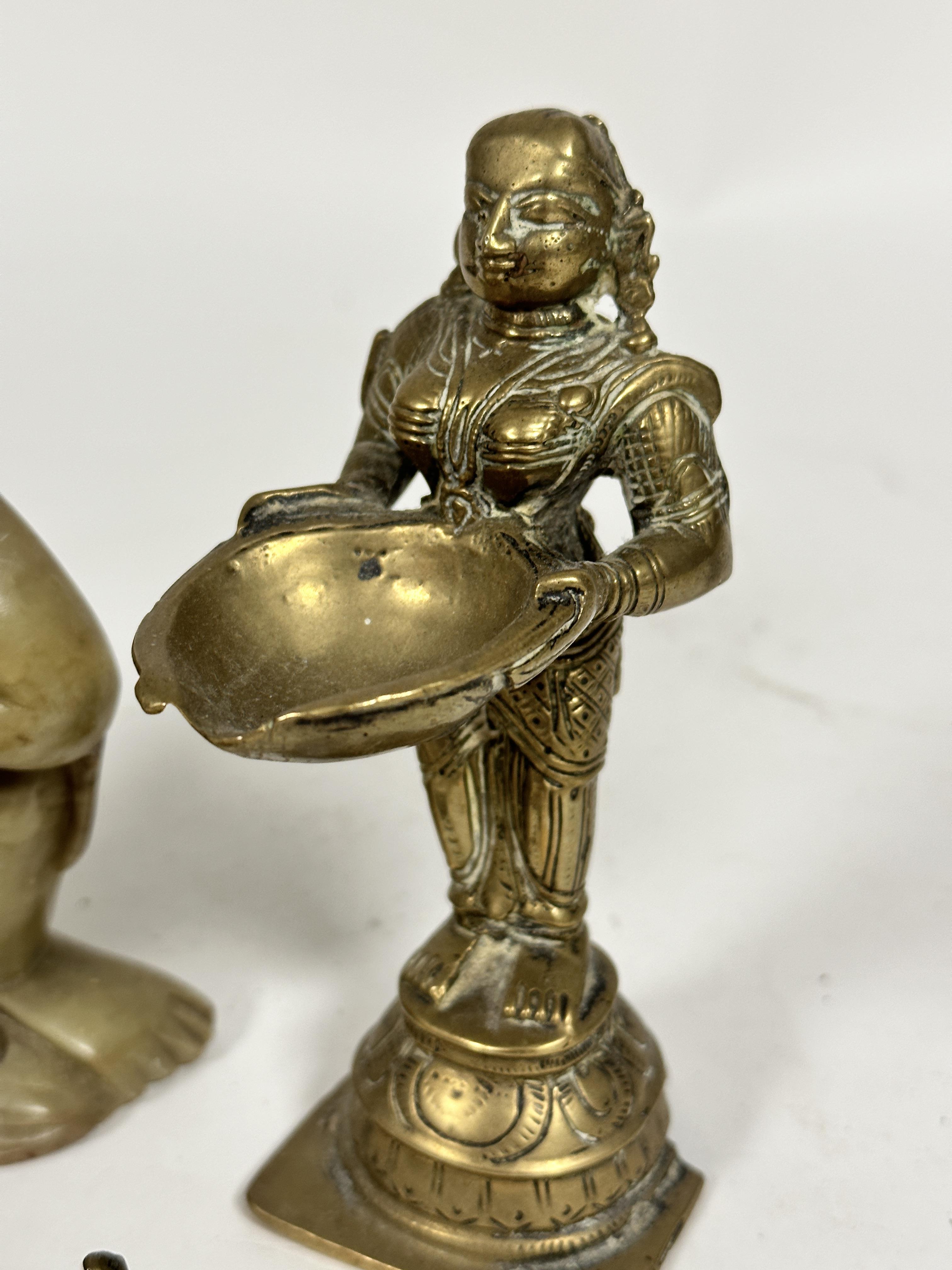 An Indian cast brass standing figure of a goddess with lotus shaped incense holder dish, raised on - Image 3 of 4