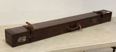 An early 20th century tin bound mahogany fishing rod box, with leather straps and buckles and