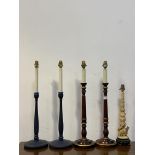 A pair of parcel gilt and stained turned beech table lights formed as candle sticks (H63cm) together