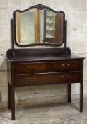 An early 20th century mahogany dressing chest, the swing mirror over two short and one long