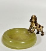A circular alabaster ashtray mounted with coal painted bronze figure of a Cocker Spaniel, (8cm x