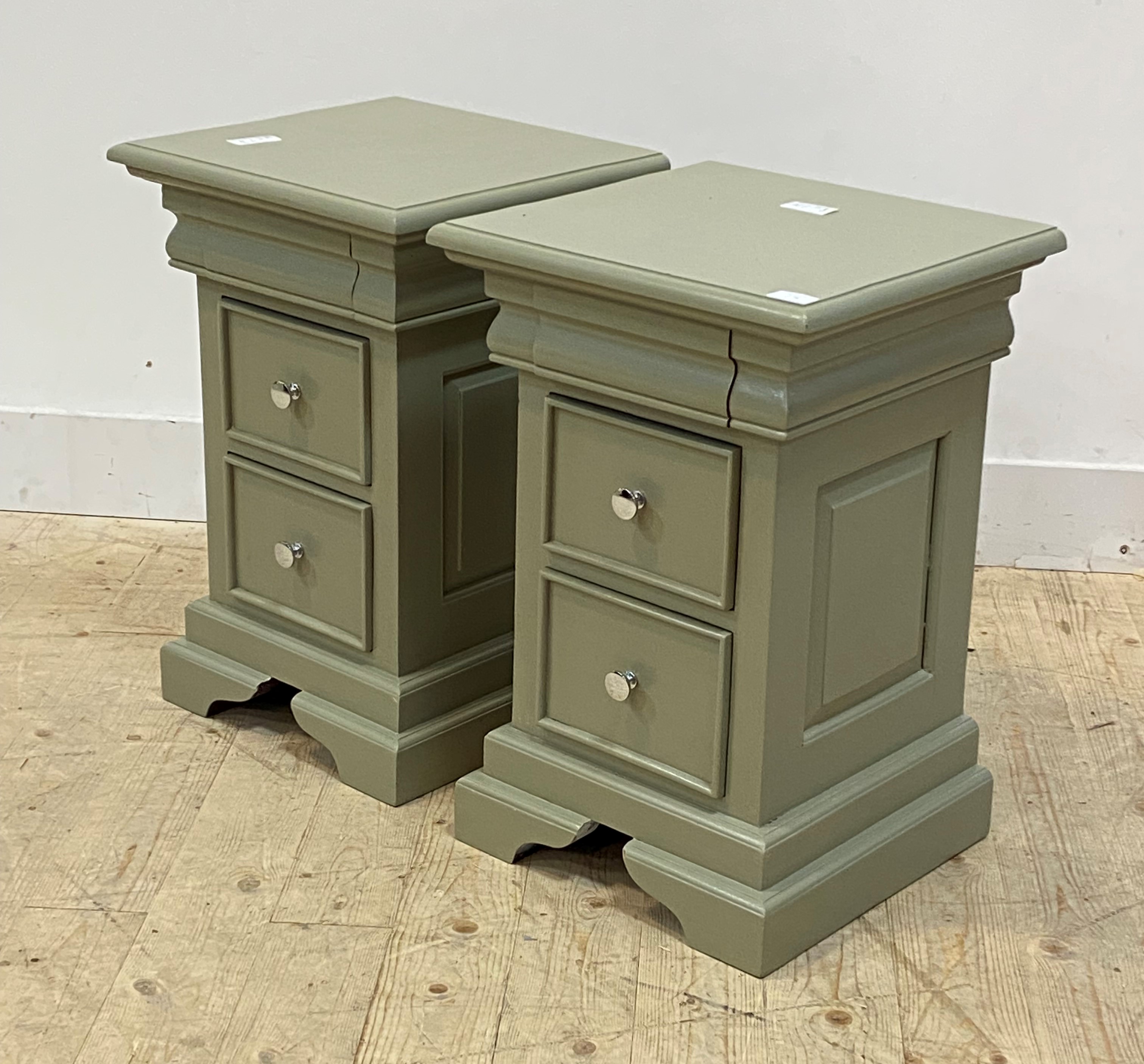 A pair of green painted hardwood bedside chests, each fitted with three drawers raised on bracket