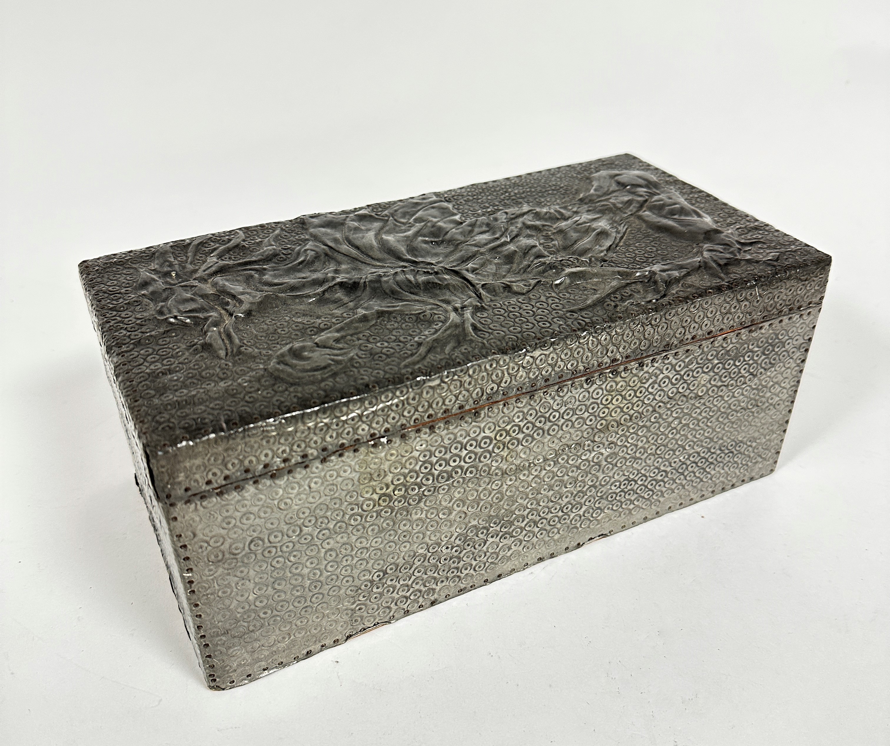An Arts & Crafts style rectangular pewter chased mounted lined cigar box with impressed name to