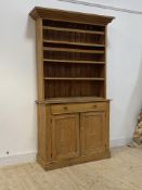 A Victorian country pine dresser, the projecting cornice over three height plate rack, above a