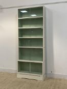 A large white painted six height stacking library bookcase by Minty, each tier with sliding glass