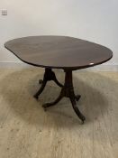 A Reproduction Regency style twin pillar dining table with one leaf