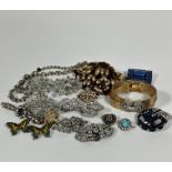 A paste gilt metal bracelet, a paste set cluster brooch, a paste ribbon brooch, two Deco style