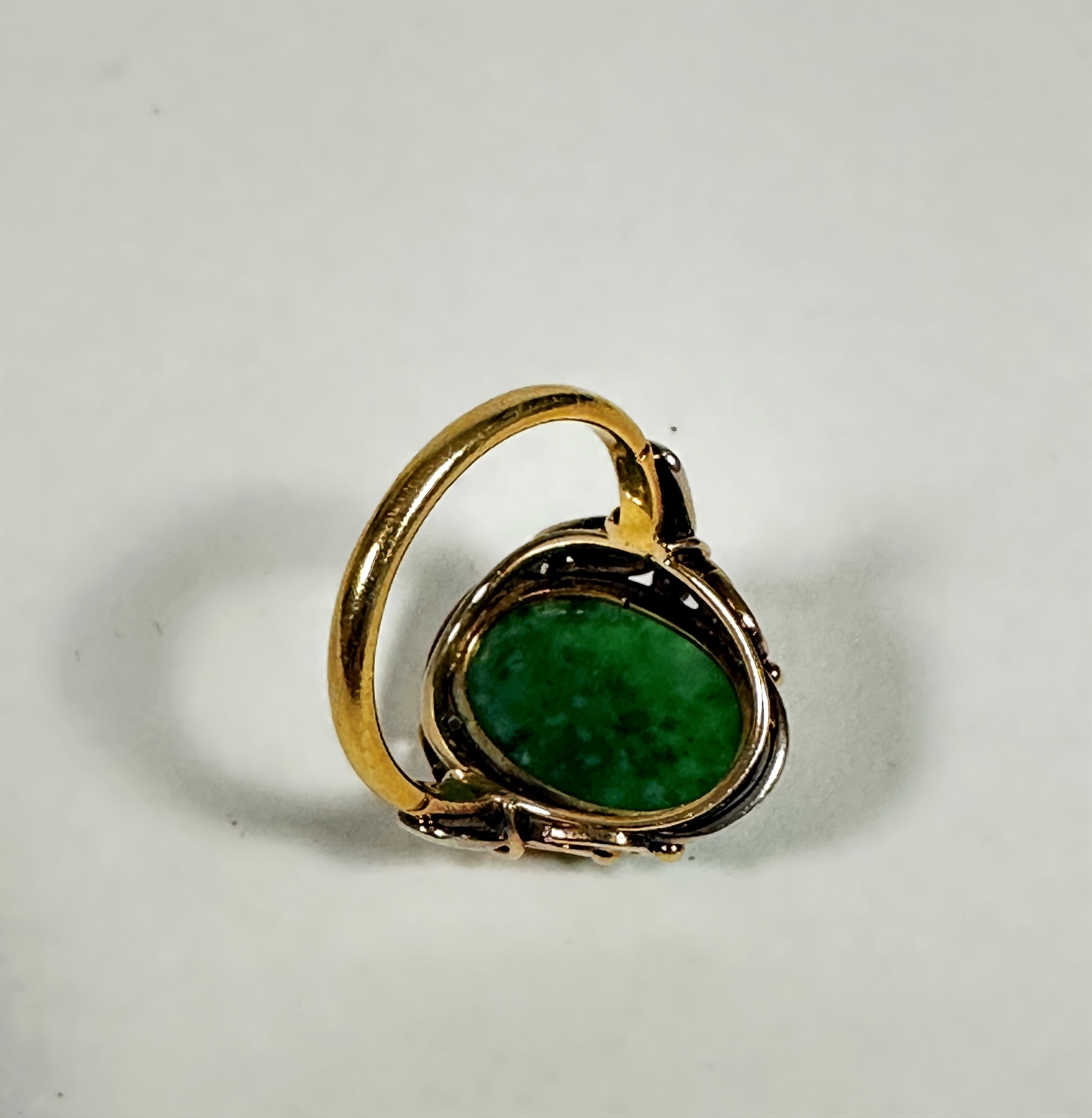 An 18ct gold dress ring set oval relief carved jadeite carved panel (2cm x 1cm) mounted in open work - Image 2 of 3