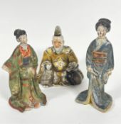 A pair of Japanese pottery standing figures of two women in traditional costume, both with heads