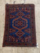 A Persian Hamadan hand knotted rug, the blue field with typical design and bordered 157cm x 104cm