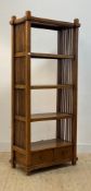 A stained hardwood three height open shelf, with slatted sides and two drawers to base, H195cm,