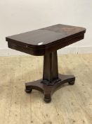A mid 19th century mahogany fold over tea table, the top raised on a faceted concave tapering
