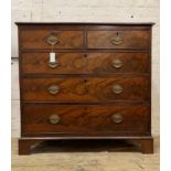 An early 19th century mahogany chest of drawers, fitted with two short and three long graduated