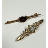 An 9ct gold Edwardian style bar brooch with oval amethyst with open work setting, (L: 15cm) and a