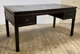 A Chinese style black lacquered writing table, the panelled top over two drawers, raised on square