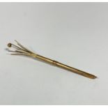 A 9ct gold engine turned decorated swizzle stick