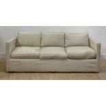 A contemporary three seat sofa of rectangular outline, with loose cover and squab cushions
