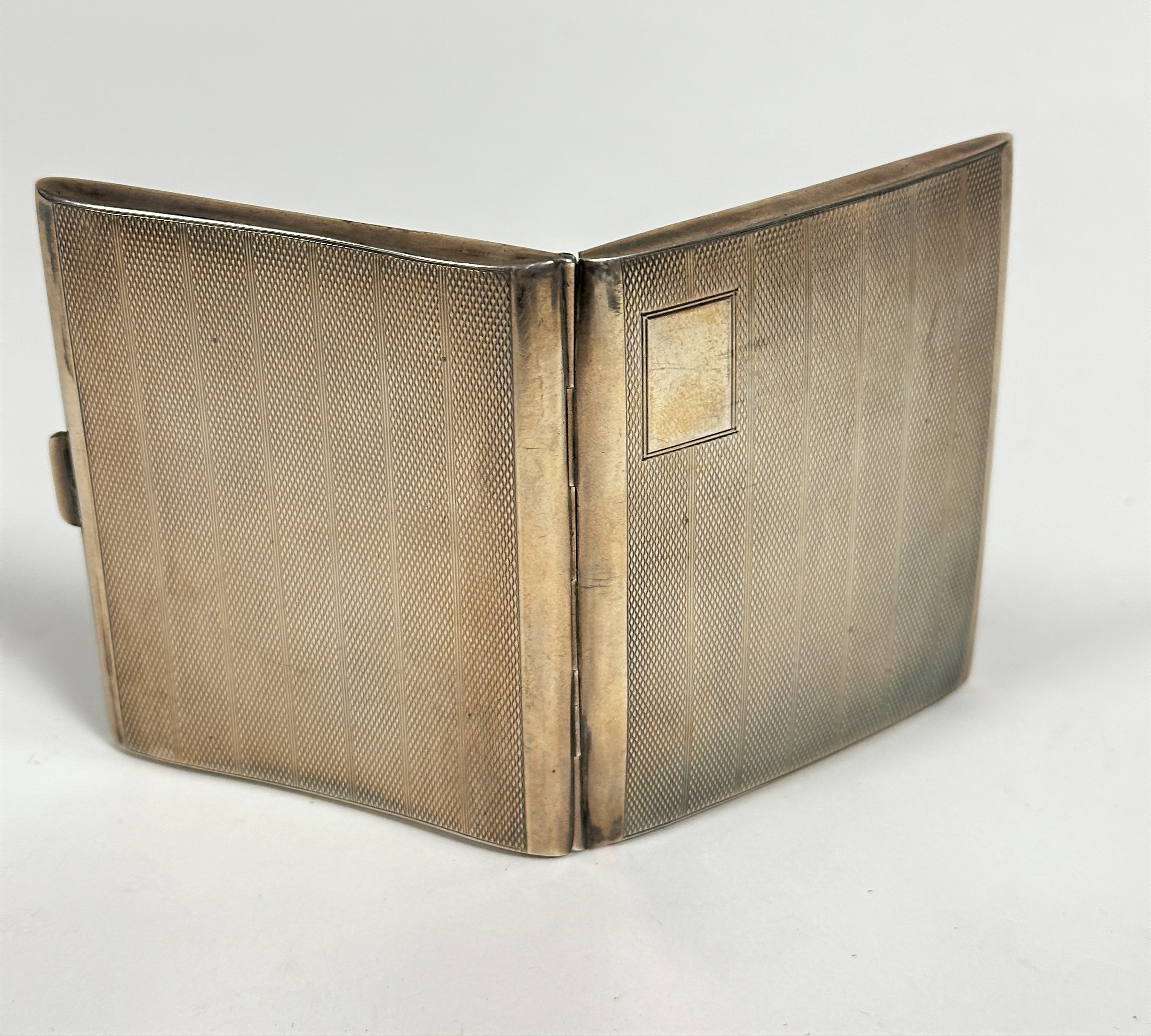 A Birmingham 1929 silver presentation cigarette case with engine turned decoration with engraved