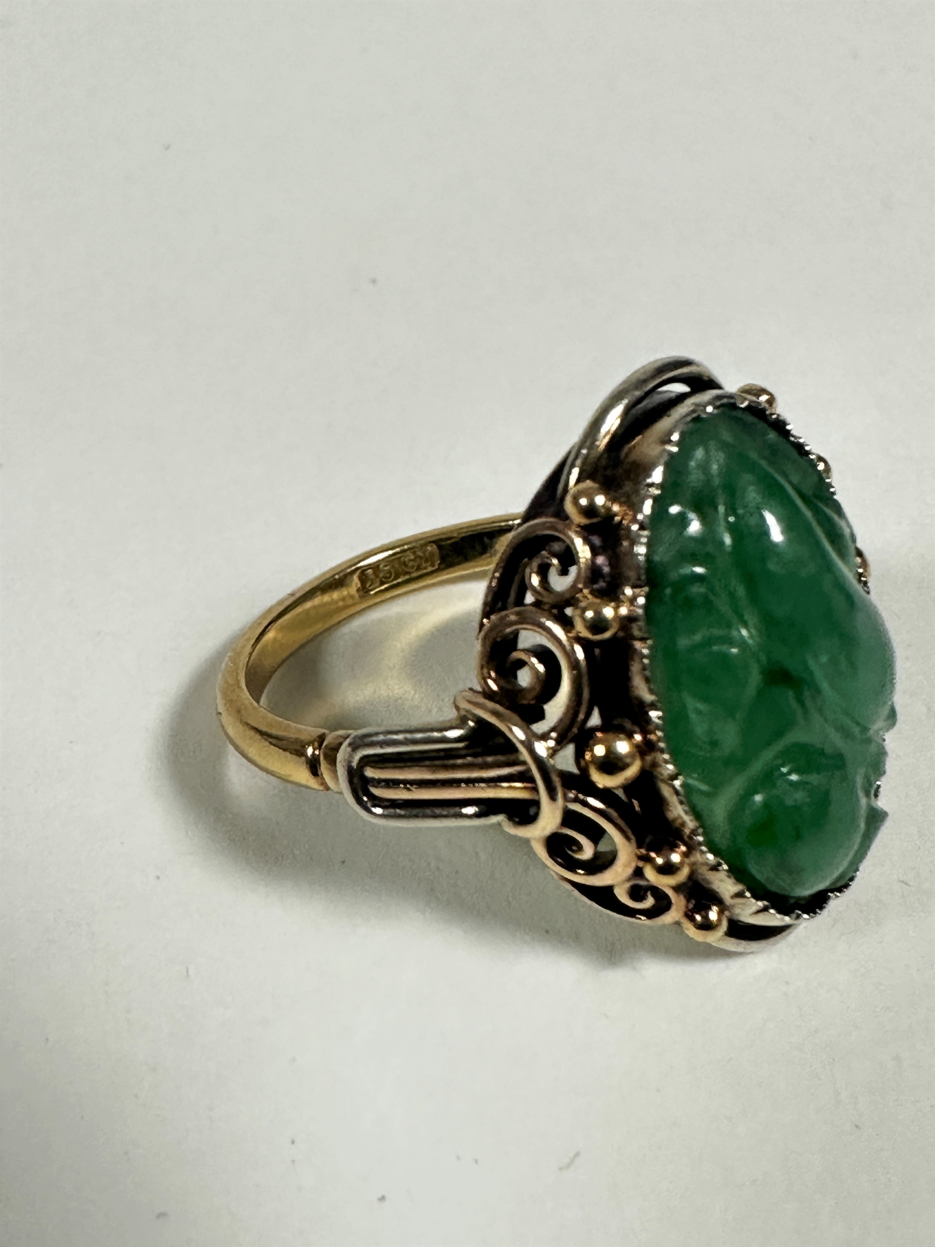 An 18ct gold dress ring set oval relief carved jadeite carved panel (2cm x 1cm) mounted in open work - Image 3 of 3