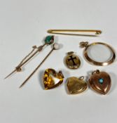 A 9ct gold heart shaped locket set turquoise, a circular open glazed pendant, a 9ct gold tie pin,