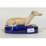 A 19th century Staffordshire lead glazed earthenware penholder, modelled as a recumbent greyhound,