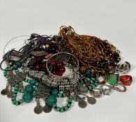 A collection of costume jewellery including a glass multiple strand bead necklace, an Eastern