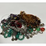 A collection of costume jewellery including a glass multiple strand bead necklace, an Eastern
