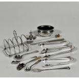 A silver four division miniature toast rack raised on bun feet, (h: 7cm x 6.5cm) marks rubbed, a