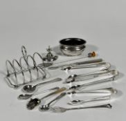 A silver four division miniature toast rack raised on bun feet, (h: 7cm x 6.5cm) marks rubbed, a