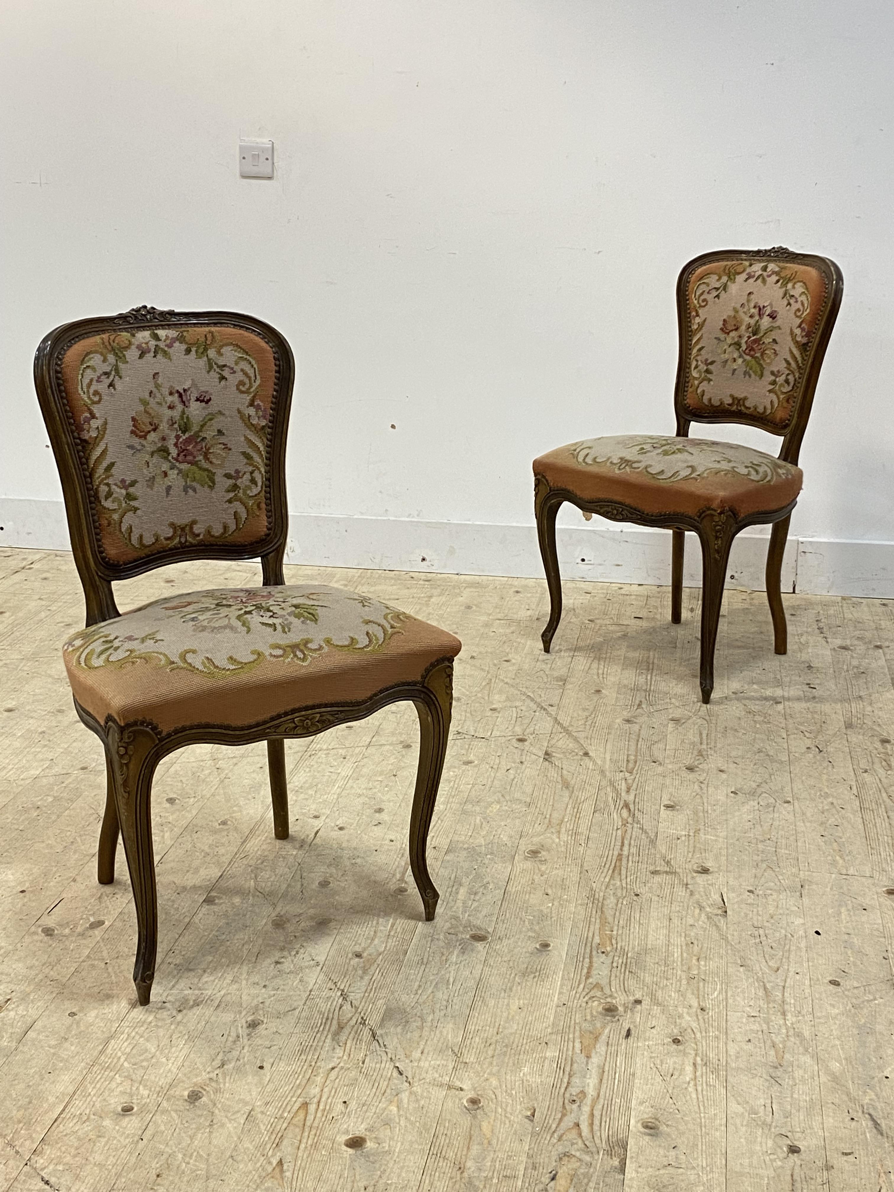 A pair of French Louis XV style beech framed bedroom chairs, early 20th century, with needlepoint