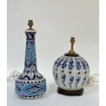 A pair of ceramic lamp bases, one Chinese blue and white with design of dragons and phoenix (h-