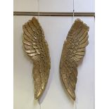A pair of gilt composotion wall hanings formed as angel wings L106cm