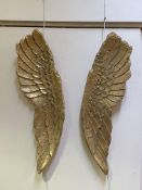 A pair of gilt composotion wall hanings formed as angel wings L106cm