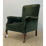 An early 20th century easy chair, upholstered in bottle green corduroy, raised on front cabriole