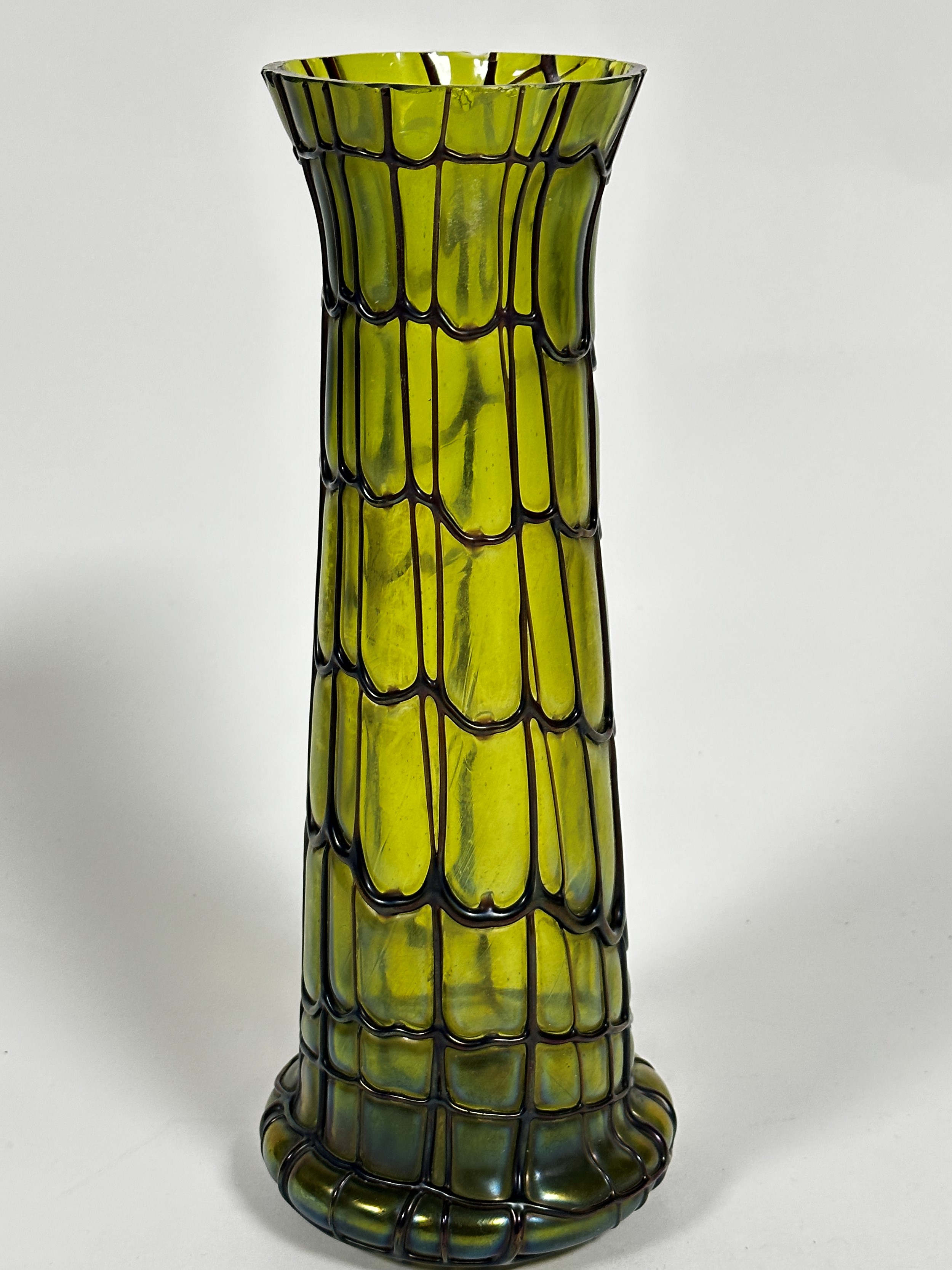 An Edwardian green lustre glass tapered cylinder vase with spreading foot with overlaid brown