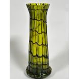 An Edwardian green lustre glass tapered cylinder vase with spreading foot with overlaid brown