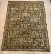 A machined Persian style garden rug, the field with floral panels within a border with running dog