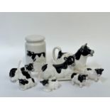 A novelty cow condiment set comprising a butter dish, a creamer ( l - 25cm), two salt shakers, two