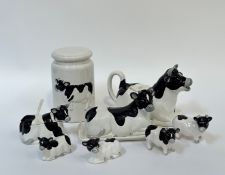 A novelty cow condiment set comprising a butter dish, a creamer ( l - 25cm), two salt shakers, two