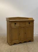 A Victorian pine side cabinet, the galleried top over three drawers and two cupboards flanked by