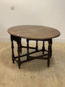 A late 18th century oak gateleg table, the oval top raised on turned and block supports, H71cm,