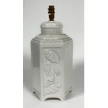 A china octagonal panelled vase lamp decorated with shell panelled alternating design, raised on