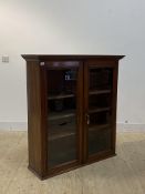 A mahogany wall hanging cabinet, early 19th century, the two glazed doors enclosing three shelves,