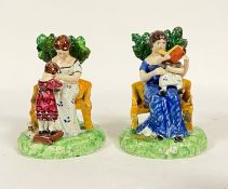 A pair of early 19th century Staffordshire lead glazed pearlware figures, each formed as a seated