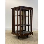 A large Edwardian mahogany revolving bookcase, with three adjustable shelves, on a four point base