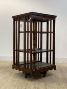 A large Edwardian mahogany revolving bookcase, with three adjustable shelves, on a four point base