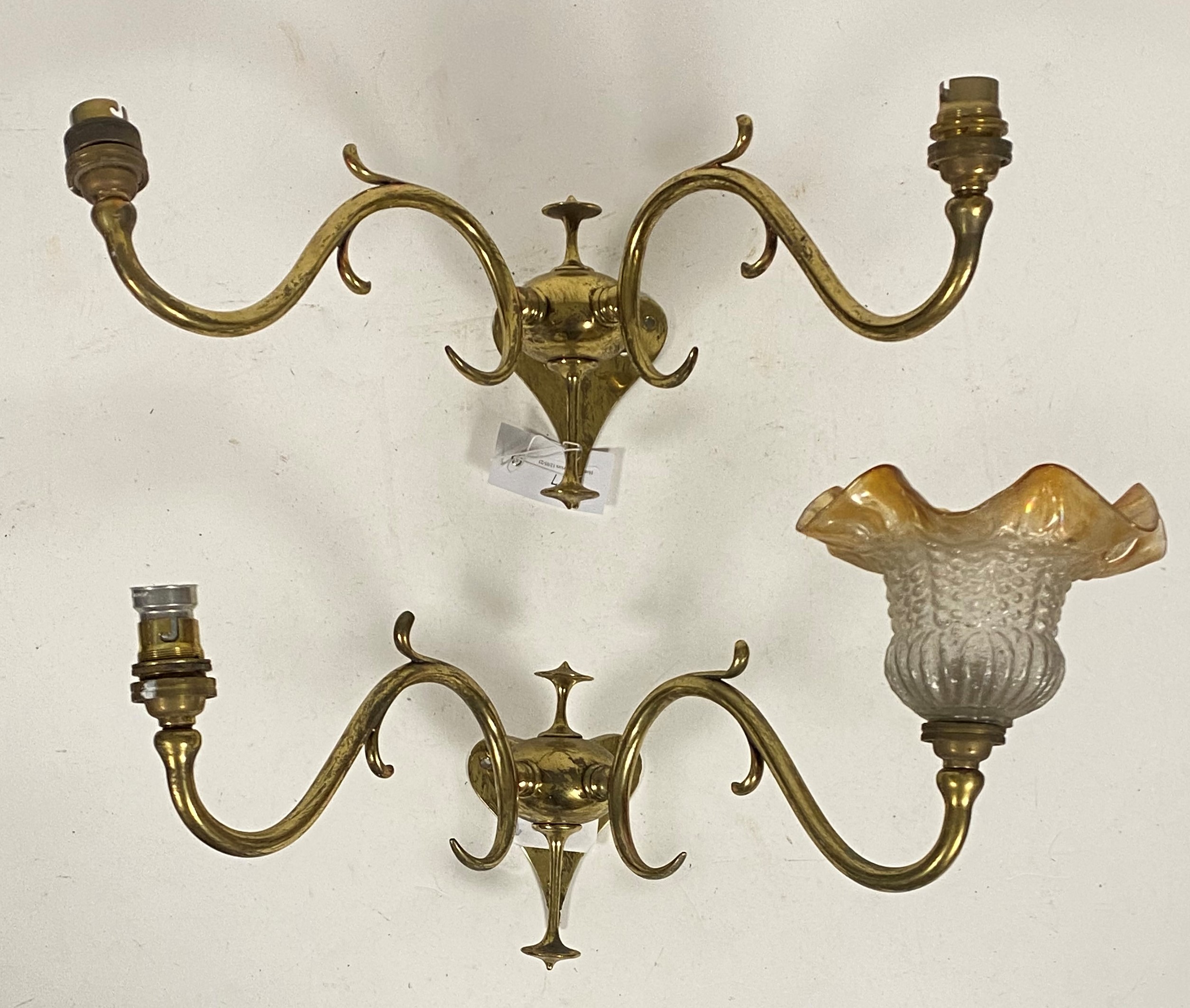 A pair of Art Nouveau period brass twin branch wall sconces