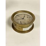 A brass ship's bulkhead type clock, late 19th / early 20th century, silvered dial with Roman chapter
