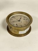 A brass ship's bulkhead type clock, late 19th / early 20th century, silvered dial with Roman chapter