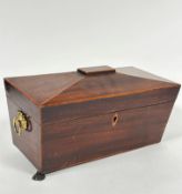 A Regency mahogany sarcophagus shaped tea caddy with satinwood inlaid border enclosing a fitted